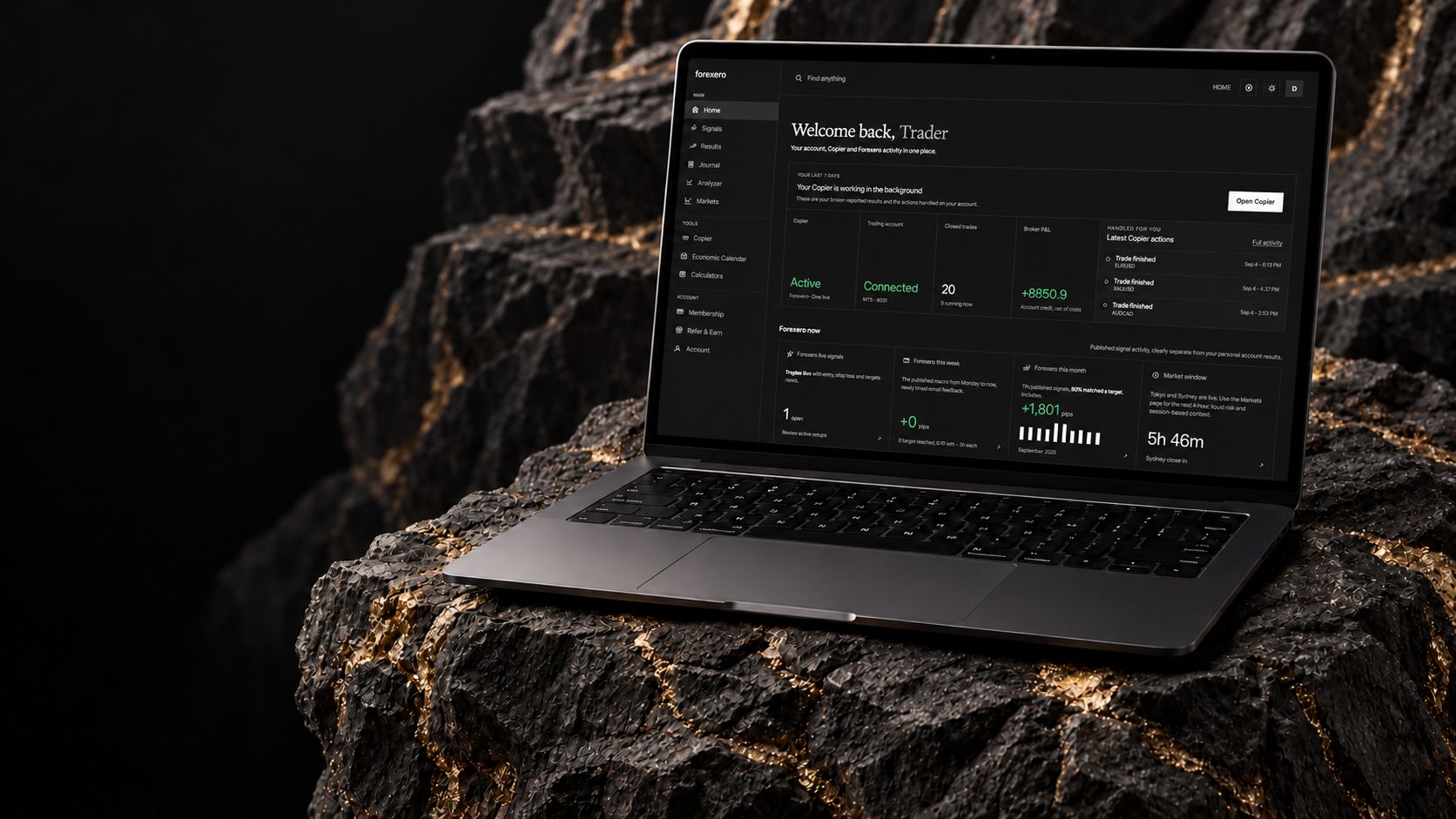 Forexero app on a MacBook in a charcoal stone setting with gold veins.